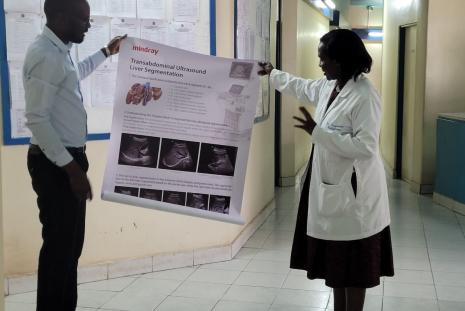 The chairperson of the Radiology department Dr Onyambu receiving ultrasound teaching support materials 